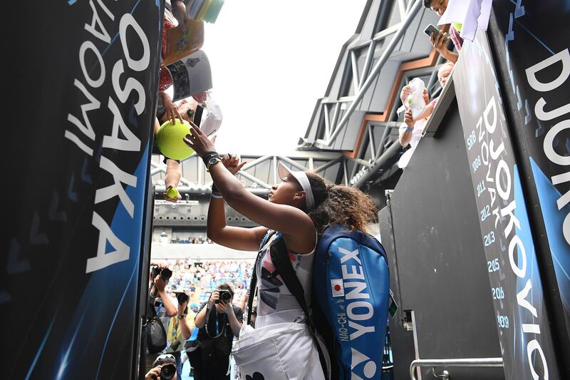 MELBOURNE, AUSTRALIA - JANUARY 22: Naomi Osaka of Japan signs autographs for fans after winning her Women's Singles second round match against Saisai Zheng of China on day three of the 2020 Australian Open at Melbourne Park on January 22, 2020 in Melbourne, Australia. (Photo by Quinn Rooney/Getty Images)