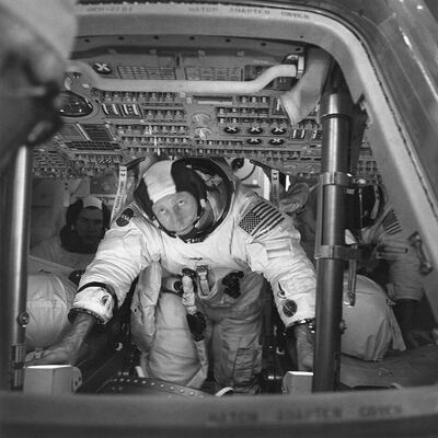 This March 26, 1971 photo made available by NASA shows astronauts Al Worden, center, Dave Scott, left, and Jim Irwin in the Command Module for an altitude chamber test at Cape Canaveral, Fla. Worden, who circled the moon alone in 1971 while his two crewmates tried out the first lunar rover, has died at age 88, his family said Wednesday, March 18, 2020. (NASA via AP)