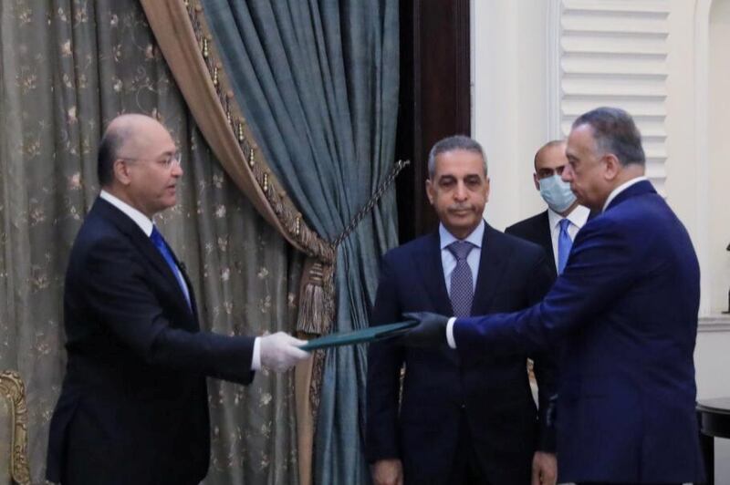 Iraq's President Barham Salih instrcuts newly appointed Prime Minister Mustafa al-Kadhimi in Baghdad, Iraq April 9, 2020. The Presidency of the Republic of Iraq Office/Handout via REUTERS ATTENTION EDITORS - THIS IMAGE WAS PROVIDED BY A THIRD PARTY.
