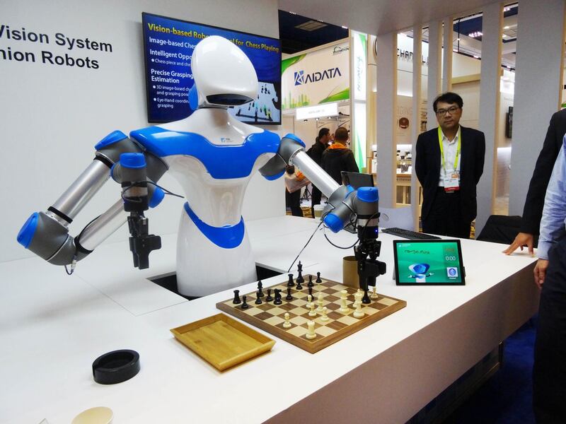 (FILES) This file photo taken on January 08, 2017 shows a robot developed by Taiwan engineers moving chess pieces on a board against an opponent at the 2017 Consumer Electronic Show (CES) in Las Vegas, Nevada.  
Giving gadgets brains will be a hot theme at the Consumer Electronics Show set to open in Las Vegas, with device makers big and small touting hardware with "smarts." Whether it's a doorbell or refrigerator, a TV set or a toothbrush, chances are it will be connected to digital assistants powered by artificial intelligence aiming to anticipate needs or desires. One of the largest trade shows in the world, the January 9-12 CES will attract some 170,000 visitors and 3,900 exhibitors from 150 countries and will showcase innovations in computers, gaming, robotics, vehicle technology, virtual and augmented reality and more.
 / AFP PHOTO / Rob Lever