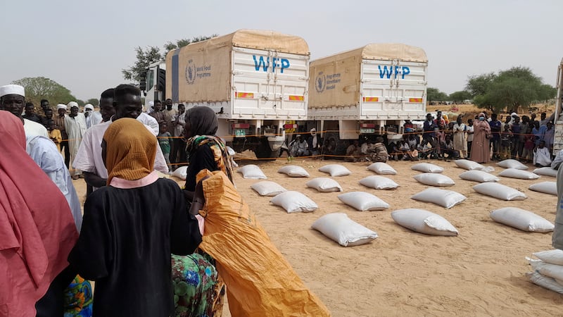 Sudanese refugees queue to receive aid from the World Food Programme near the border between Sudan and Chad in Adre, Chad. Reuters