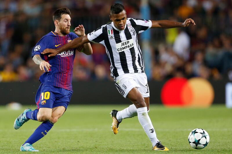 Barcelona's Lionel Messi, left, and Juventus' Alex Sandro vie for the ball during a Champions League group D soccer match between FC Barcelona and Juventus at the Camp Nou stadium in Barcelona, Spain, Tuesday, Sept. 12, 2017. (AP Photo/Francisco Seco)