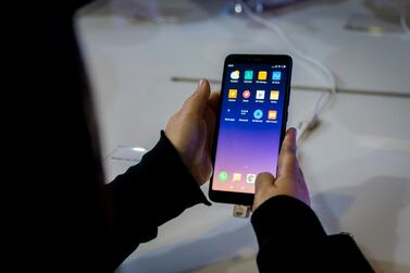 A visitor holds the Redmi S2 smartphone during the official launch of the Chinese brand Xiaomi on December 05, 2018 in Santiago, Chile. Getty Images