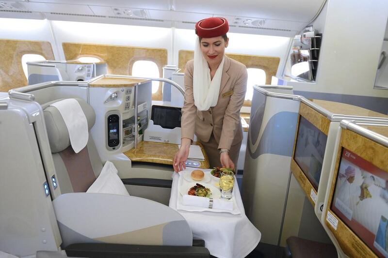 A flight attendant serves a meal at the executive suite cabin of an Emirates Airbus A380. Noah Seelam / AFP