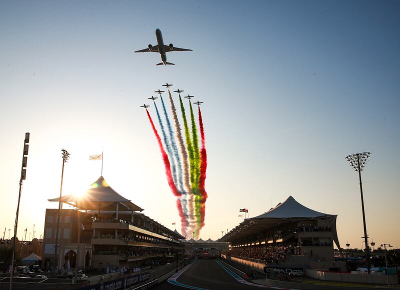 A fly past by Etihad Airways and Al Fursan aerobatics team during the UAE national anthem before the start of the Abu Dhabi Grand Prix at Yas Marina Circuit. Victor Besa / The National