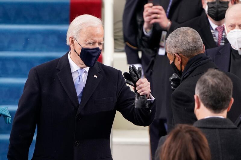 President-elect Joe Biden his greeted by former President Barrack Obama as he arrives for the 59th Presidential Inauguration at the U.S. Capitol in Washington, Wednesday, Jan. 20, 2021.(AP Photo/Patrick Semansky, Pool)