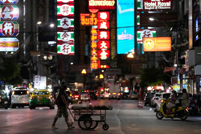 A vegetable vendor pushes his cart across a street in China Town in Bangkok, Thailand. AP Photo / Sakchai Lalit