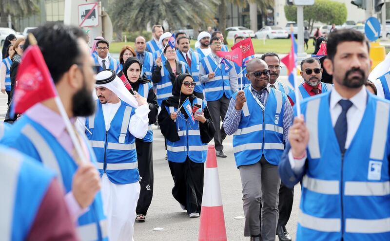ABU DHABI , UNITED ARAB EMIRATES , March 3 – 2019 :- ADNOC employees and people participating in the march of ADNOC’s “Flame of Hope” at the Founder’s memorial in Abu Dhabi. ( Pawan Singh / The National ) For News/Online/Instagram/Big Picture. Story by John