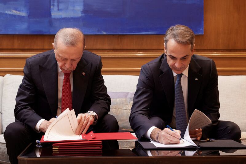 The two leaders sign a joint declaration to pursue good neighbourly relations. Greek Prime Minister’s Office / Reuters