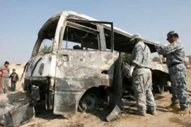 Policemen inspect a burnt bus at the site of a bomb attack in eastern Baghdad.