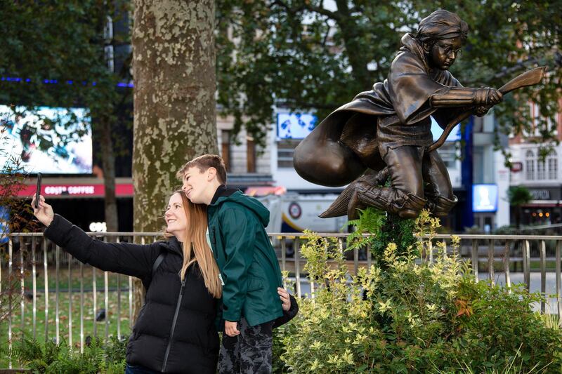 Harry Potter fans take a selfie photograph in front of the new statue of the character Harry Potter, after it was unveiled in Leicester Square as part of the Scenes in the Square statue trail, central London. AP Photo