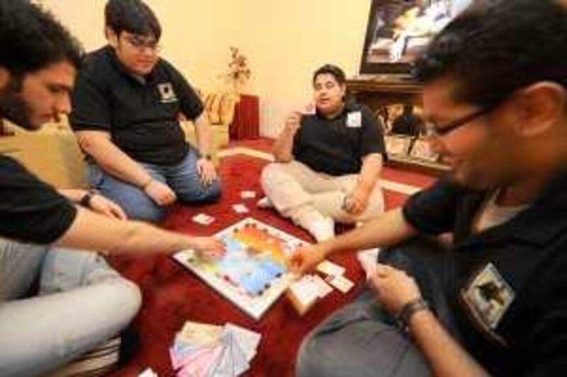 SEPTEMBER 12, 2009, KUWAIT: Young Kuwaiti guys (check with James Calderwood for names) play with there new monopoly  who started selling a local version of it in Kuwait. Raed Qutena for The National *** Local Caption ***  RQC_8717.JPG