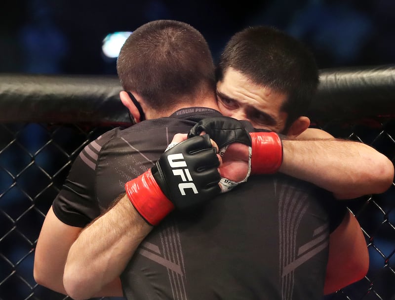 Coach Khabib Nurmagomedov celebrates the win with his fighter Islam Makhachev. Chris Whiteoak / The National