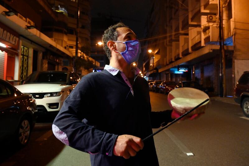 A Lebanese drummer (Musaharati) wears a protective mask and carries a small drum as he makes his rounds waking Muslims for Suhor, the meal taken during Ramadan before sunrise prayers, amid the coronavirus lockdown in Beirut, Lebanon, 25 April 2020. EPA