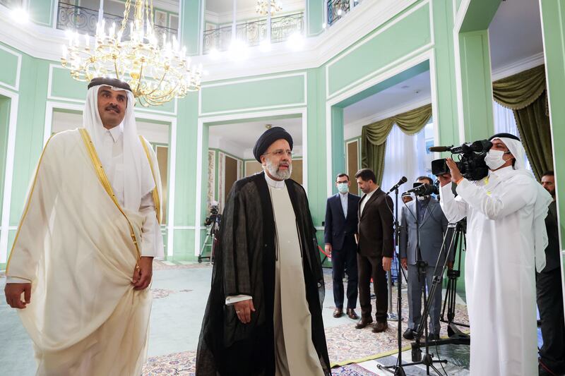 Iranian President Ebrahim Raisi (R) and Qatar's Emir Sheikh Tamim bin Hamad Al Thani arrive for a meeting at the presidential palace in Tehran, Iran. EPA