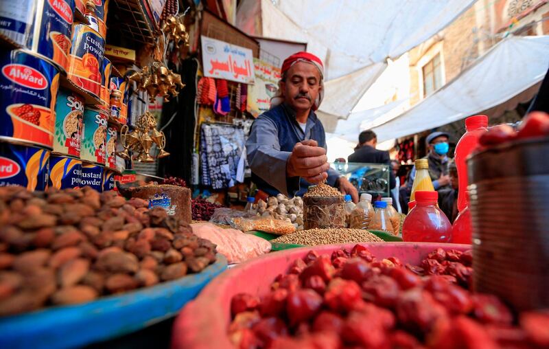 A Yemeni vendor waits for costumers in the old city market of the capital Sanaa ahead of the holy Muslim fasting month of Ramadan.   AFP