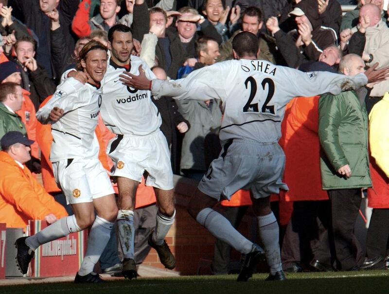 Diego Forlan celebrates with teammates Ryan Giggs, centre, and John O’Shea, right, after scoring against Liverpool for Manchester United at Anfield in 2002. Paul Barker / AFP / December 1, 2002