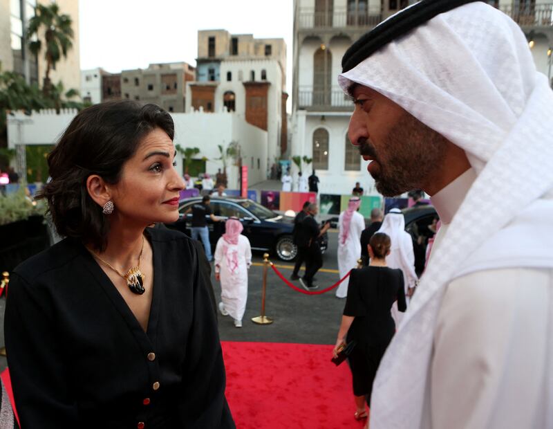 Saudi actress and director Ahed Kamel chats with Red Sea International Film Festival chairman Mohamed Turki on the red carpet. Photo: Red Sea International Film Festival / AFP