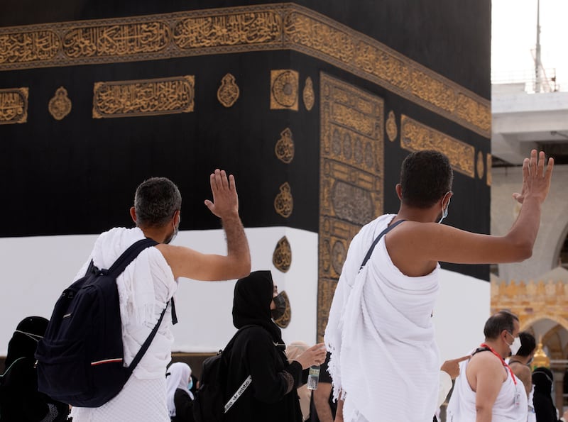 Muslim pilgrims pray in front of the Kaaba.