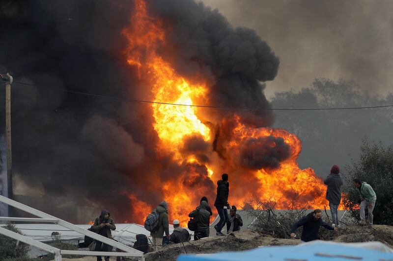 A gas canister explodes in the camp as fires rage in October 2016