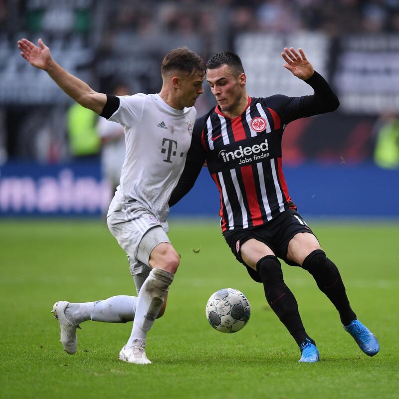 FRANKFURT AM MAIN, GERMANY - NOVEMBER 02: Joshua Kimmich of Muenchen is challenged by Filip Kostic of Frankfurt during the Bundesliga match between Eintracht Frankfurt and FC Bayern Muenchen at Commerzbank-Arena on November 02, 2019 in Frankfurt am Main, Germany. (Photo by Alex Grimm/Bongarts/Getty Images)
