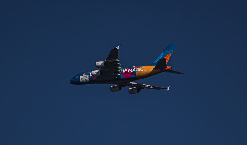 An Emirates A380 with Expo 2020 livery flying over Jumeirah Beach and Sheikh Zayed Road in Dubai, on October 13, 2021.  EPA