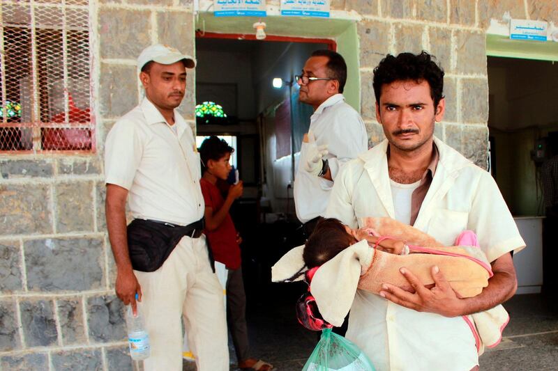 Salwa Ibrahim, a five-year-old girl suffering from acute malnutrition and weighing three kilograms, is carried by her father as they leave a treatment centre in Yemen's northern Hajjah province on June 23, 2020. The country's health system has all but collapsed since war broke out between the government and Huthi rebels in 2014, and more than two thirds of the population of about 24 million need aid to survive, according to the United Nations. / AFP / ESSA AHMED
