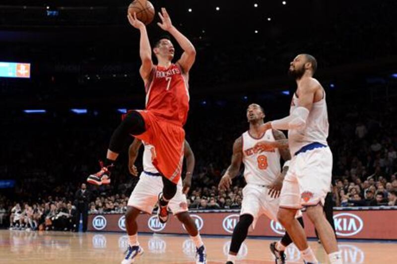 Houston guard Jeremy Lin looks to get past New York Knicks' JR Smith and Tyson Chandler.
