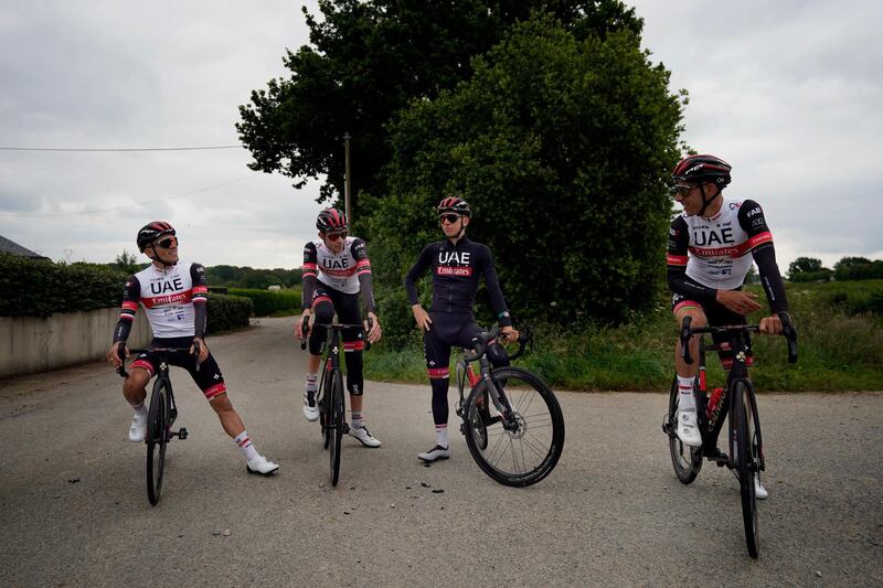 Slovenia's Tadej Pogacar centre, takes a break during a training ride with teammates. AP