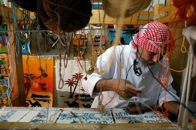 ABU DHABI - UNITED ARAB EMIRATES - 08MAY2017 - Amer Eid Ahmed who demonstrates his carpet weaving skills to tourist at Emirates Heritage village at the breakwaters in Abu Dhabi. Ravindranath K / The National (Standalone for News) *** Local Caption ***  RK0805-WEAVING05.jpg