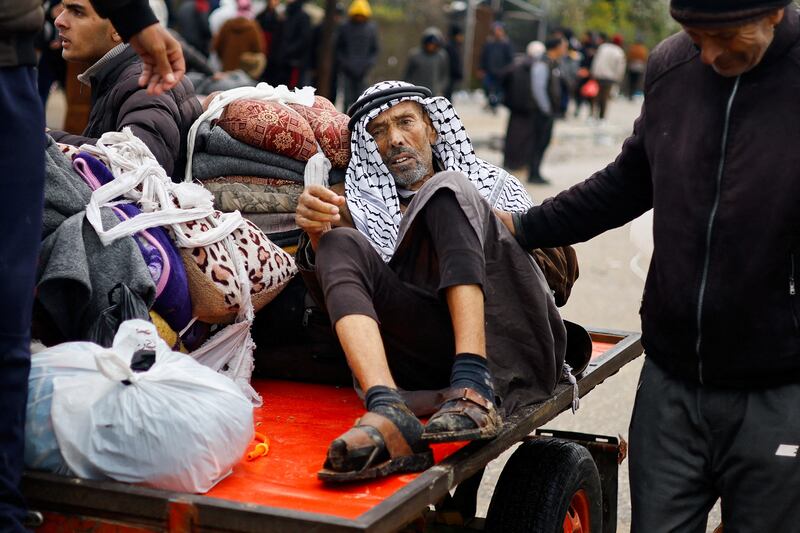 Palestinian man rides on a cart while fleeing from Khan Younis in southern Gaza amid the war with Israel. Reuters