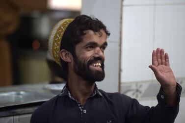 In this picture taken on February 22, 2019, Pakistani waiter Rozi Khan, 25, who resembles US actor Peter Dinklage, waving to customers at Dilbar Hotel in Rawalpindi. Rozi Khan had never heard of the Game of Thrones -- or its hugely popular character Tyrion Lannister -- until his striking resemblance to the dwarf anti-hero got heads turning at home. - To go with PAKISTAN-LIFESTYLE-TELEVISION-ENTERTAINMENT / AFP / AAMIR QURESHI / To go with PAKISTAN-LIFESTYLE-TELEVISION-ENTERTAINMENT