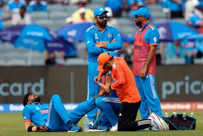Hardik Pandya receives medical attention after sustaining an injury during the 2023 ODI World Cup match against Bangladesh in Pune. Reuters
