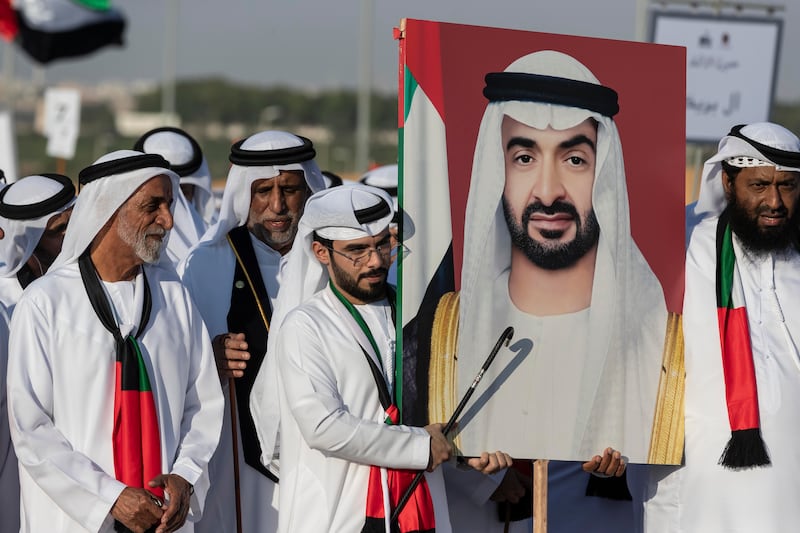 Tribe members carry a portrait of President Sheikh Mohamed.

