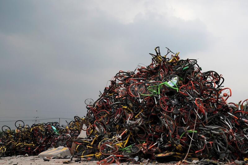 Bicycles from various bike-sharing schemes are seen in a garbage dump in Shanghai, China. Aly Song / Reuters