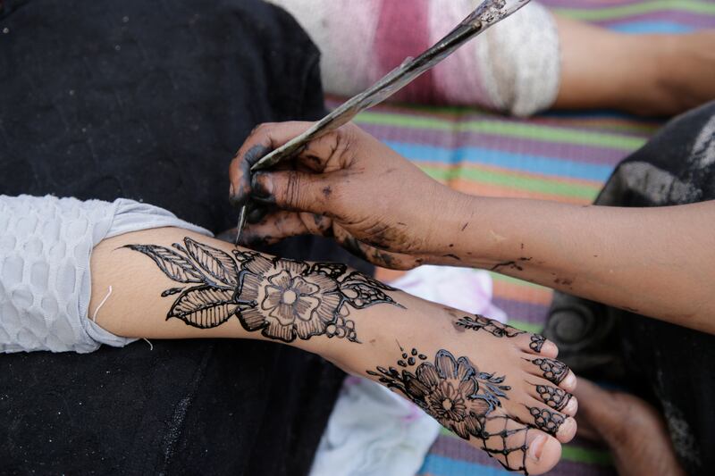 A woman has her arm decorated with henna at a street market in the run-up to Eid Al Fitr, which marks the end Ramadan, in Mogadishu, Somalia. AP