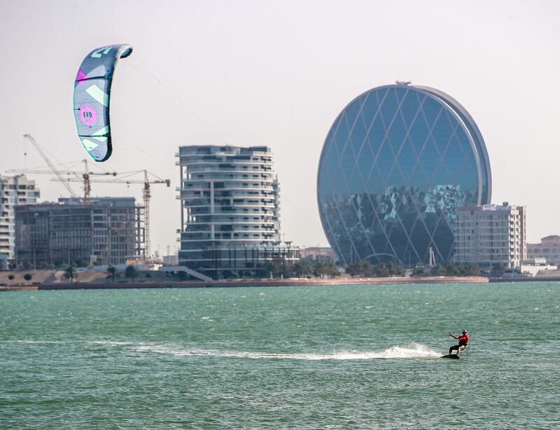 Kitesurfing enthusiasts enjoy the strong winds at Yas Bay in Abu Dhabi. Victor Besa / The National