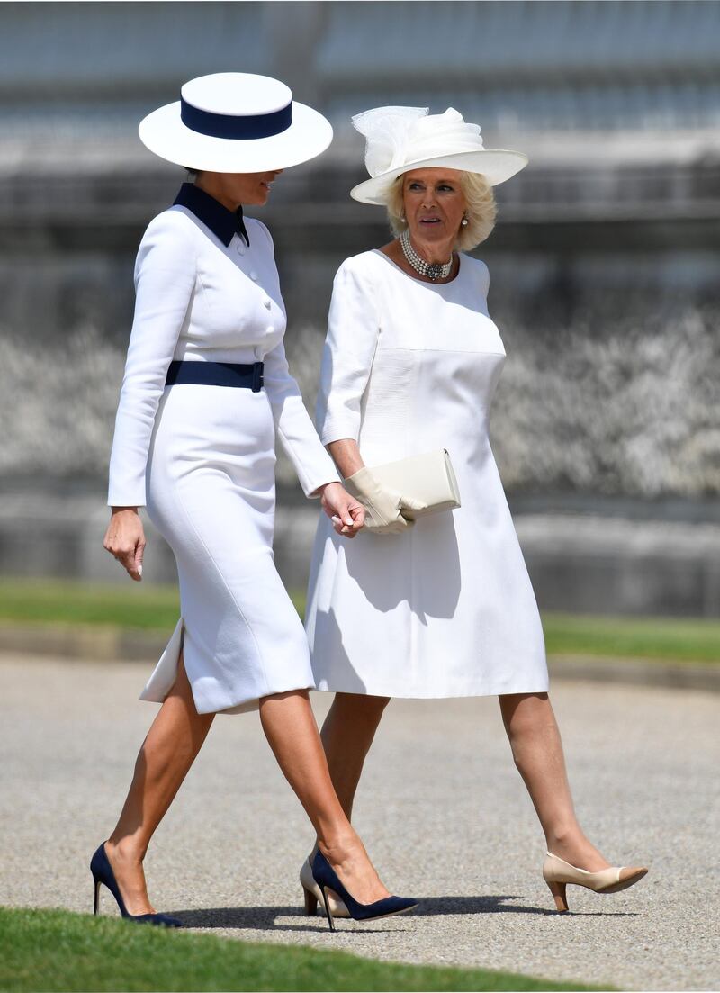 US First Lady Melania Trump (L) and walks with Britain's Camilla, Duchess of Cornwall (R) as she arrives for a welcome ceremony at Buckingham Palace. AFP