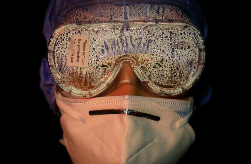 A female soldier's goggles are covered with vapor after handling bodies of coronavirus victims in Kathmandu, Nepal. Reuters