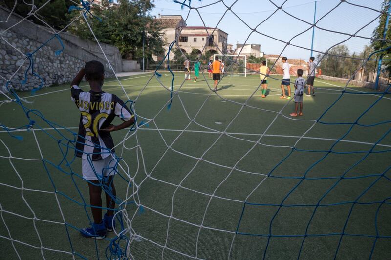 Mohammed, a young migrant living in the village with his family, plays in goal during a match. The National/Giacomo Sini