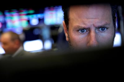 FILE PHOTO: FILE PHOTO: A trader looks at a screen at the New York Stock Exchange (NYSE) in New York, U.S., October 25, 2019. REUTERS/Brendan McDermid/File Photo