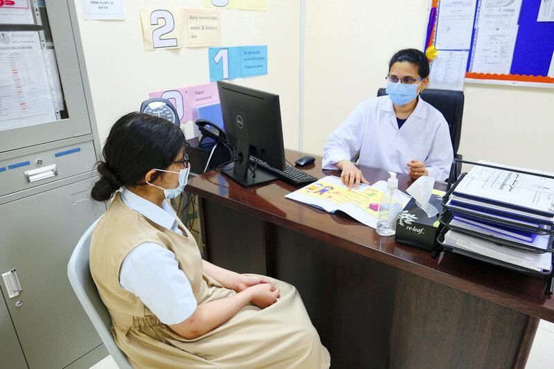 Blessy Jinu, staff nurse explaining about the Covid 19 vaccine to the student Mira Tannira at the Al Shola American School in Ajman on June 8 , 2021. Pawan Singh / The National. Story by Salam