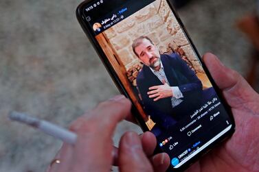 A man watches a Facebook video posted by Syrian businessman Rami Makhlouf in Damascus on May 11, 2020. AFP