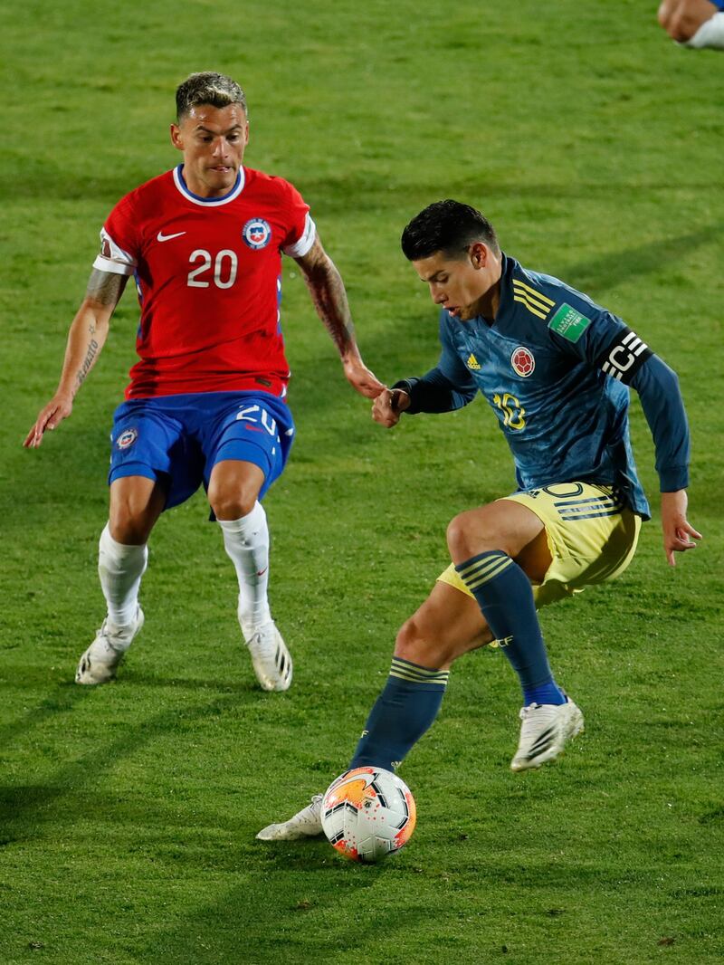 Charles Aranguiz closes down James Rodriguez. AP