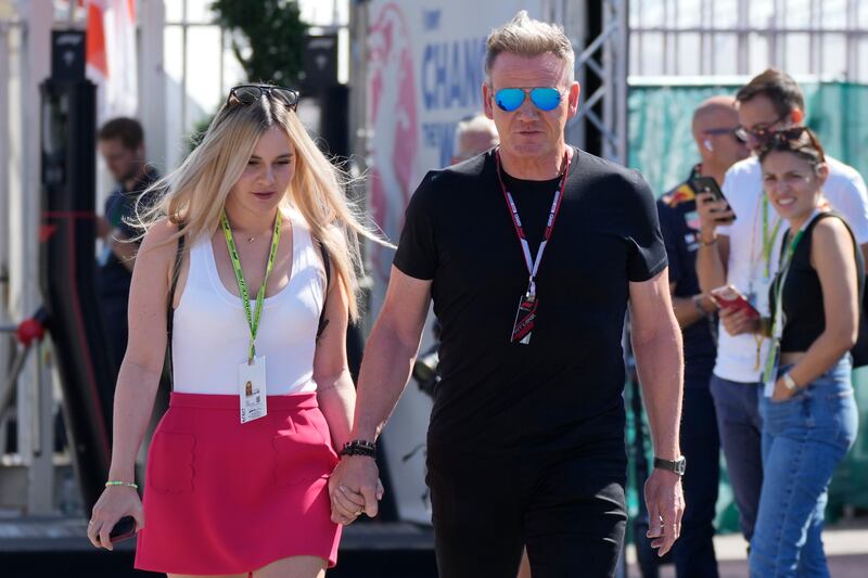 Chef Gordon Ramsay walks with his daughter Tilly through the paddock. AP