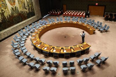 (FILES) In this file photo taken on September 20, 2017 an official looks at the empty chairs of leaders ahead of their participation in an open debate of the United Nations Security Council in New York. The UN Security Council on July 1, 2020 unanimously adopted a resolution calling for a halt to conflicts to facilitate the fight against the COVID-19 pandemic, after more than three months of painstaking negotiations, diplomats said. / AFP / POOL / Stephane LEMOUTON
