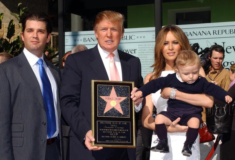 This January 16, 2007 photo shows Donald Trump with his wife Melania Trump and their son Barron Trump along with Donald Trump Jr.(L) during Donald Trump's Walk of Fame Ceremony held in front of the Kodak theater in Hollywood, California. (Photo by Chris DELMAS / AFP)