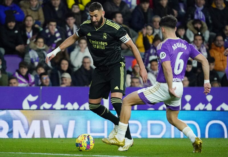 Real Madrid's French forward Karim Benzema is challenged by Real Valladolid's Spanish midfielder Alvaro Aguado. AFP