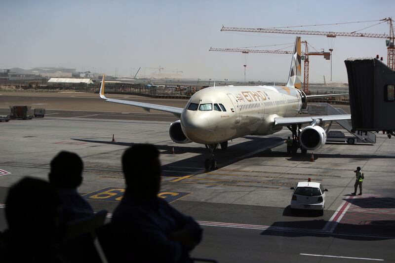 Etihad Airways passengers wait to board a flight at Abu Dhabi International Airport.  Delores Johnson / The National