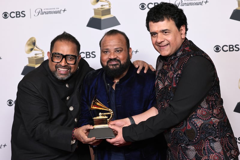Shakti members, from left, Shankar Mahadevan, Selvaganesh Vinayakram and Ganesh Rajagopalan celebrate their Grammy win. EPA